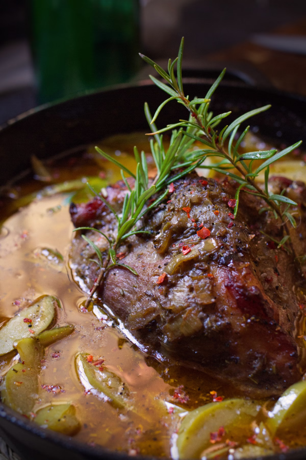 A dutch oven with some braised pork and Asturian cider