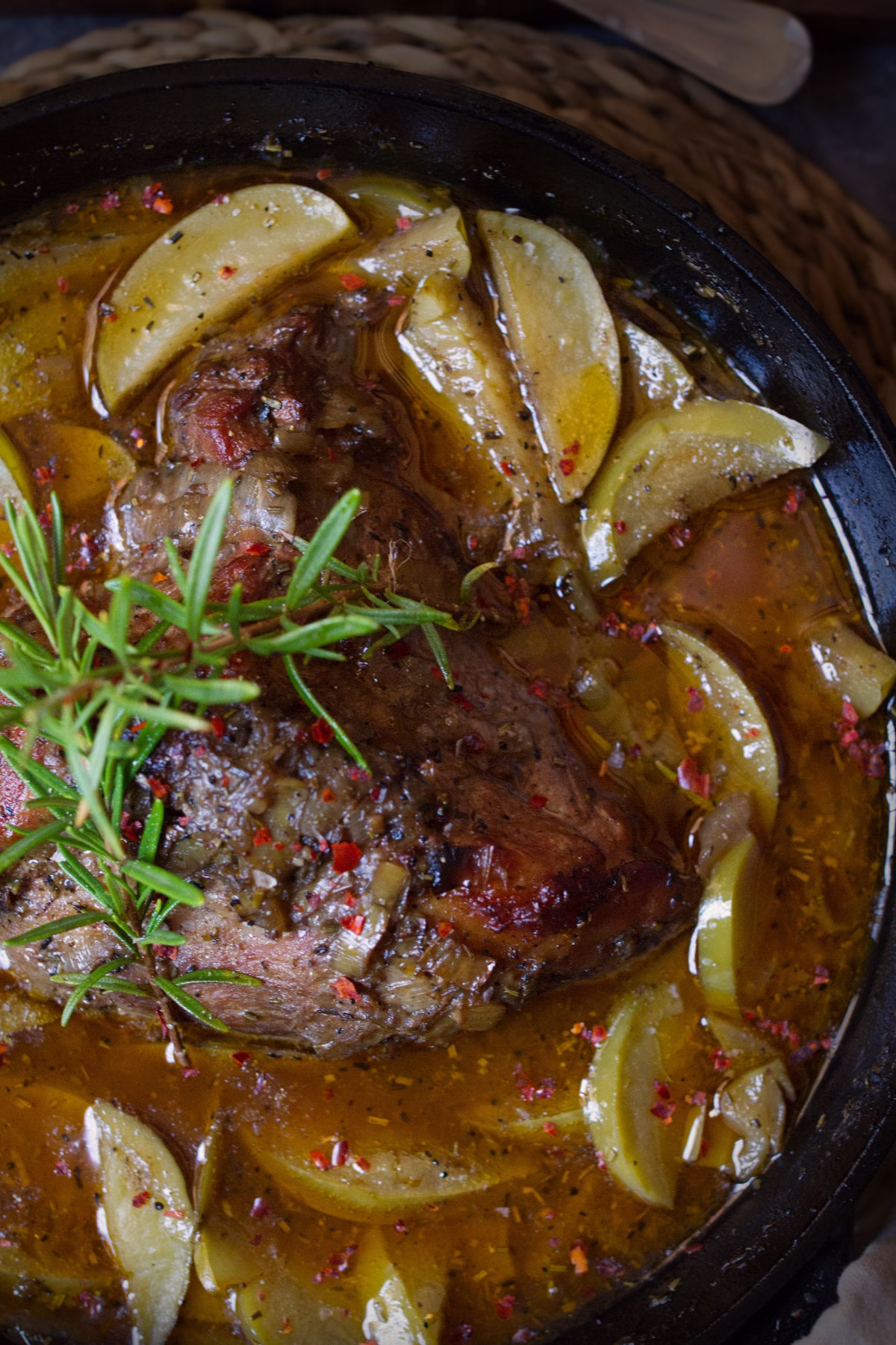 A dutch oven with some braised pork and Asturian cider