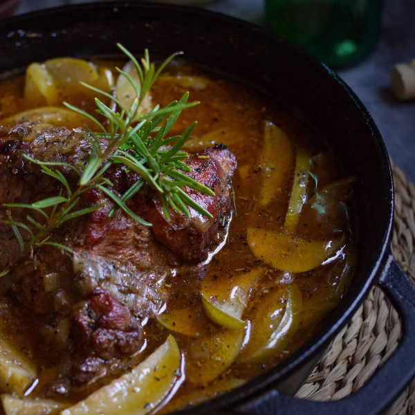A pan of Braised pork shoulder with Asturian cider