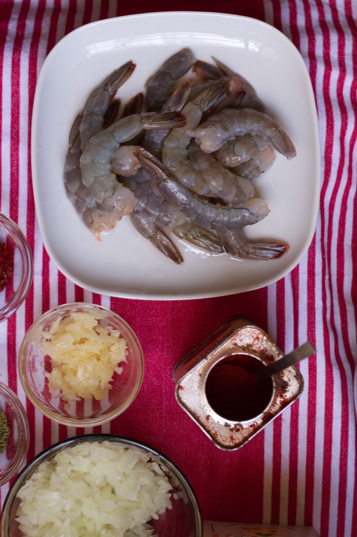 ingredients-v1 fresh raw shrimp sit beside some sweet paprika and other herbs