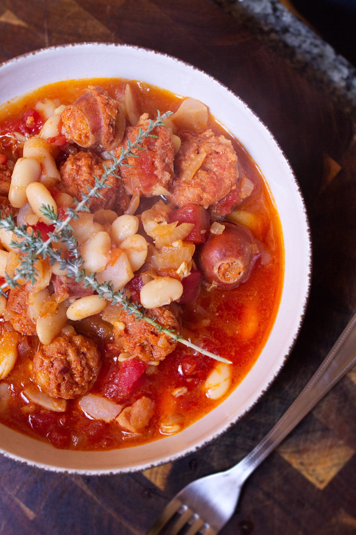 A bowl of a classic Spanish fabada with chorizo and white beans