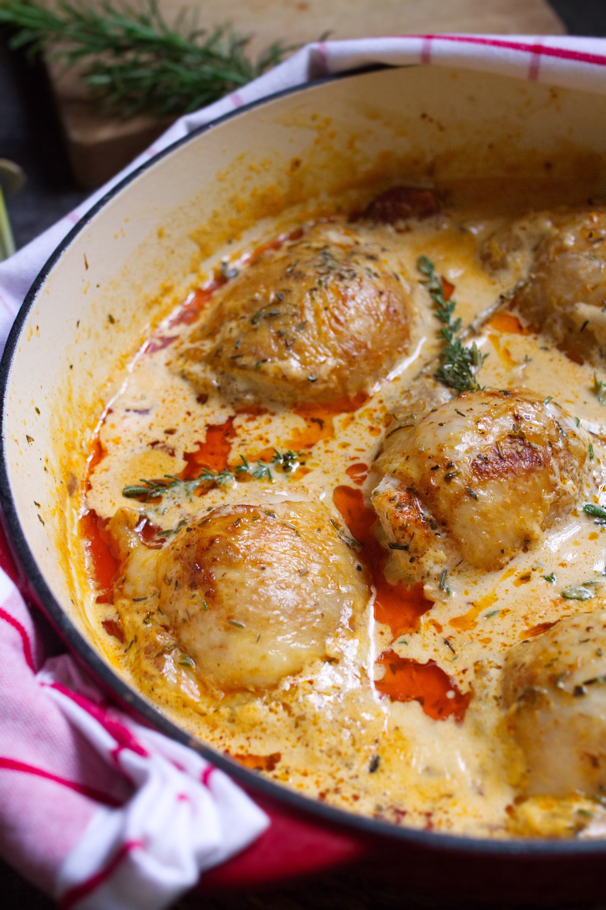 A large skillet of creamy paprika-infused chicken thighs
