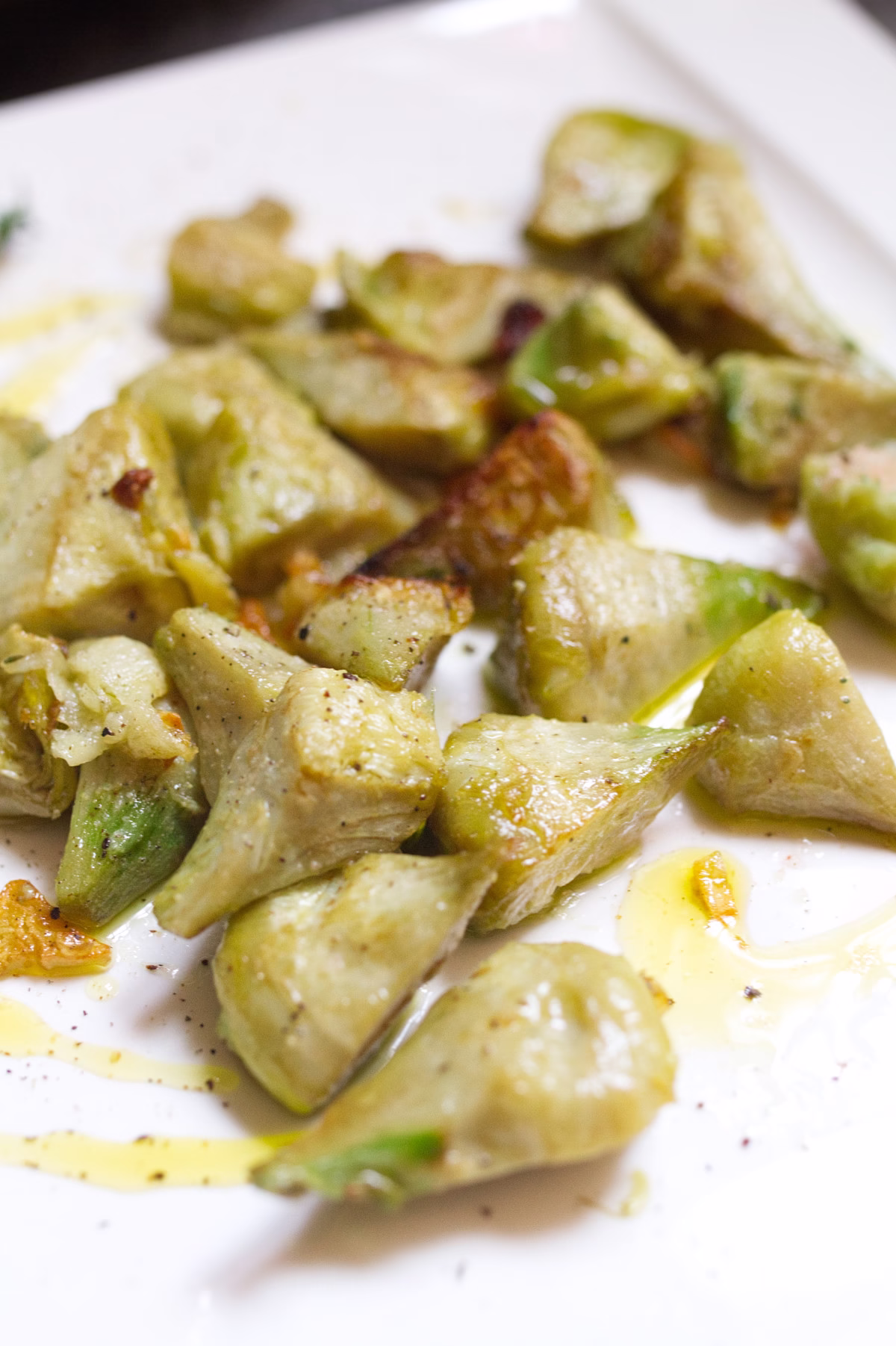 A plate of pan-fried artichoke with garlic and lemon