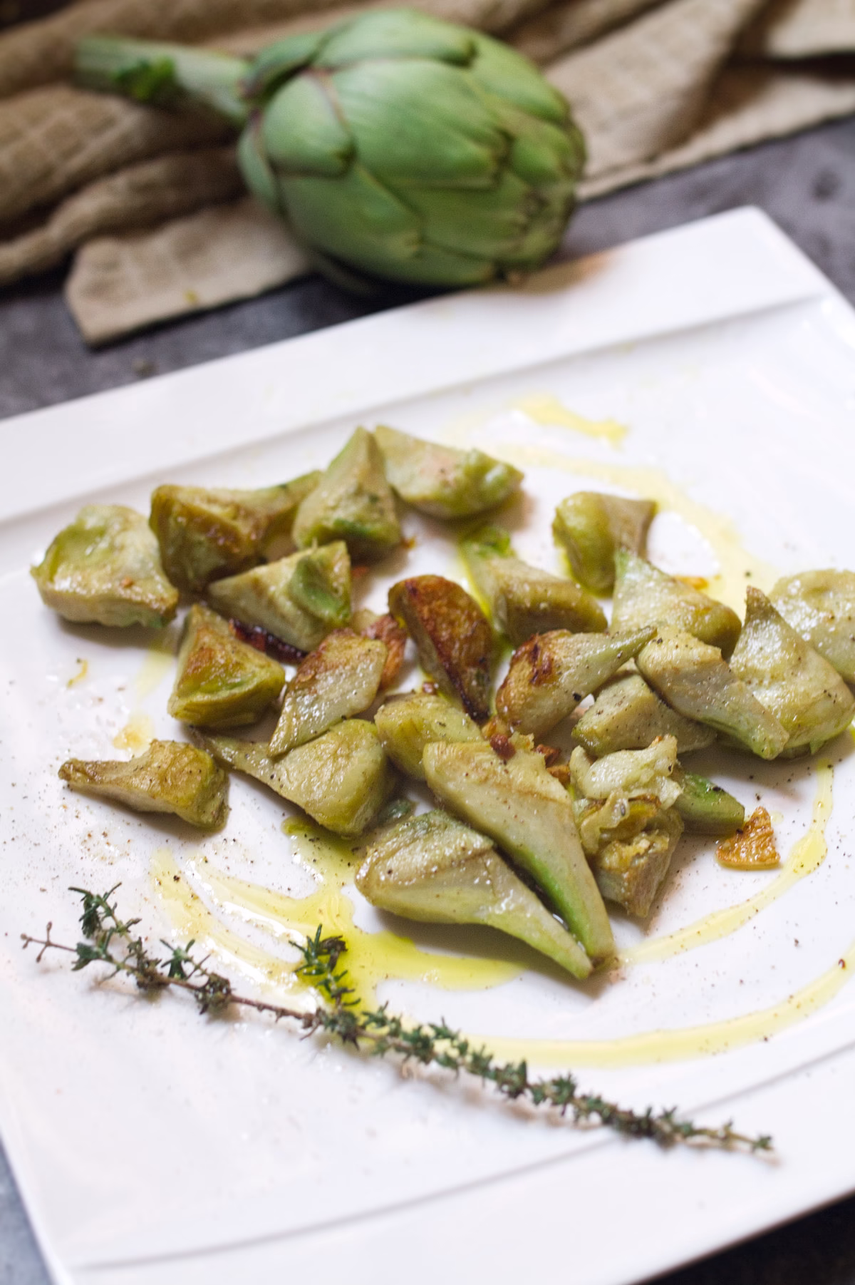 A plate of pan-fried artichoke with garlic and lemon