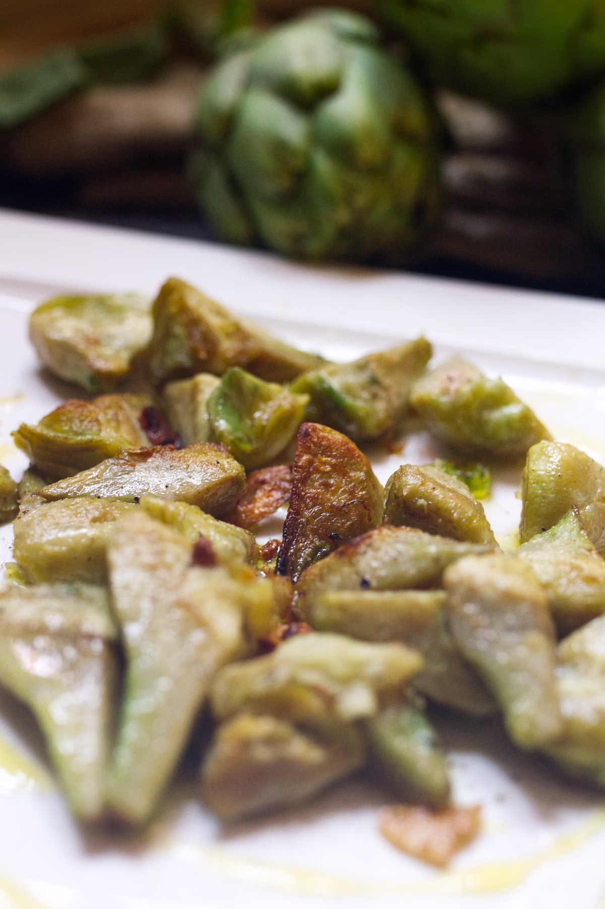 A plate of pan-fried artichoke with garlic and lemon