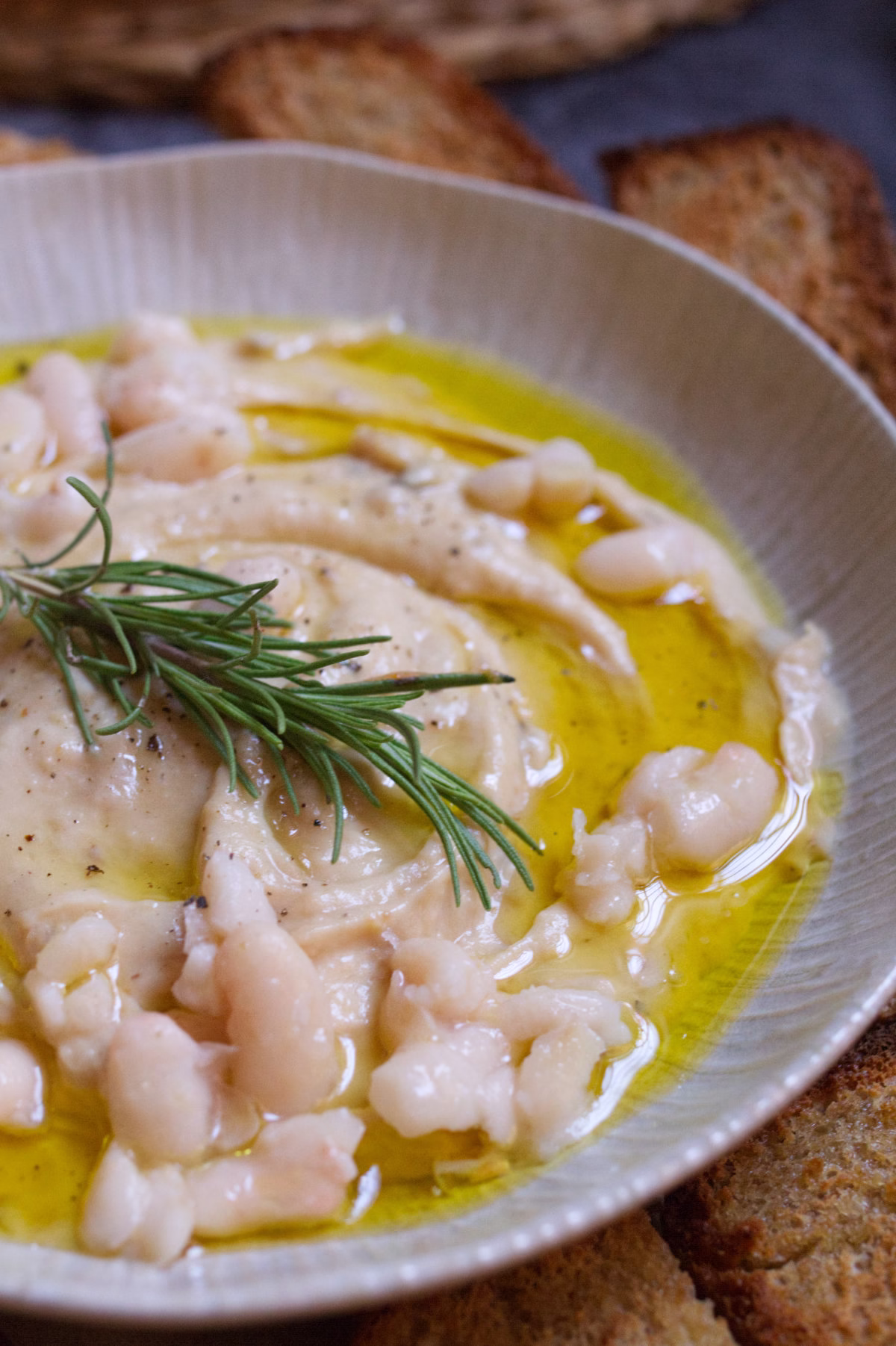 A small bowl of white bean dip with caramelized onions