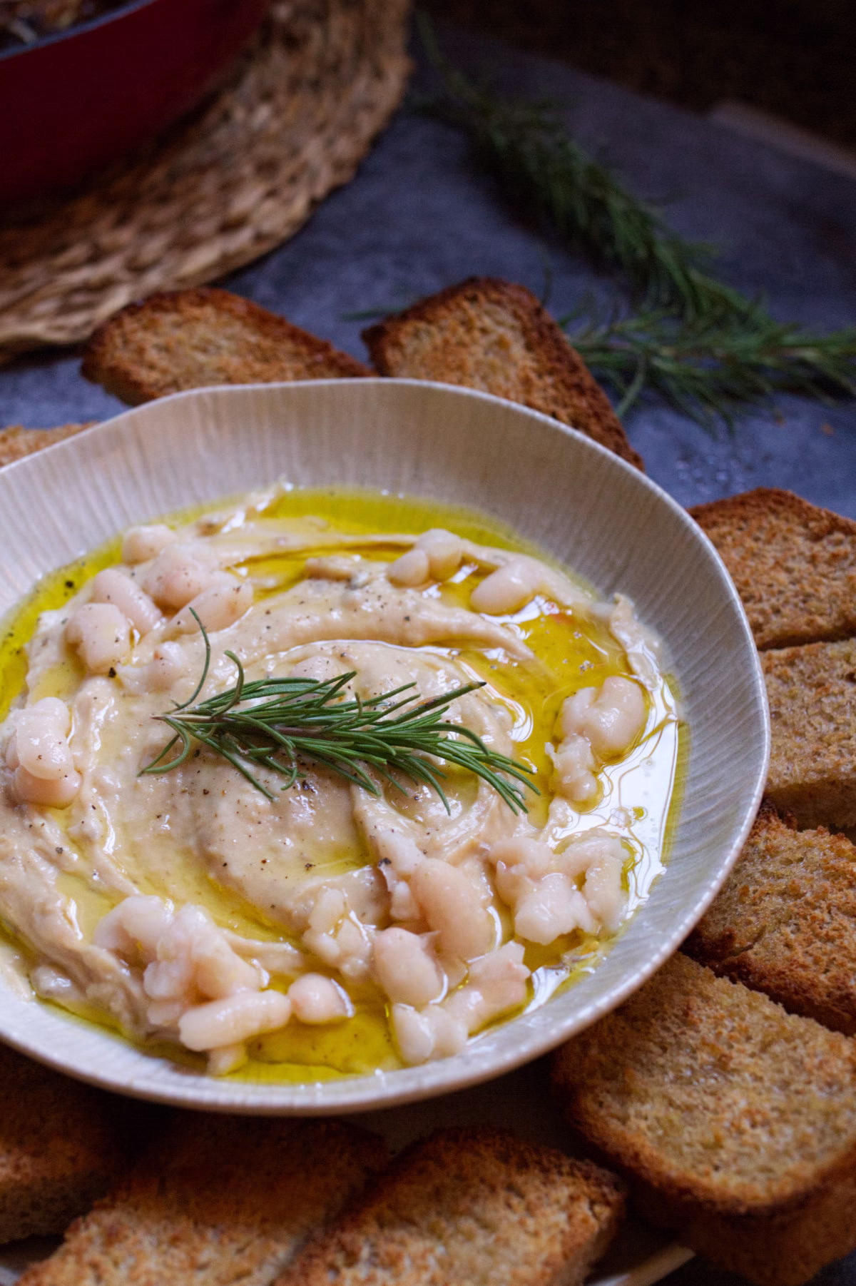 A small bowl of white bean dip with caramelized onions