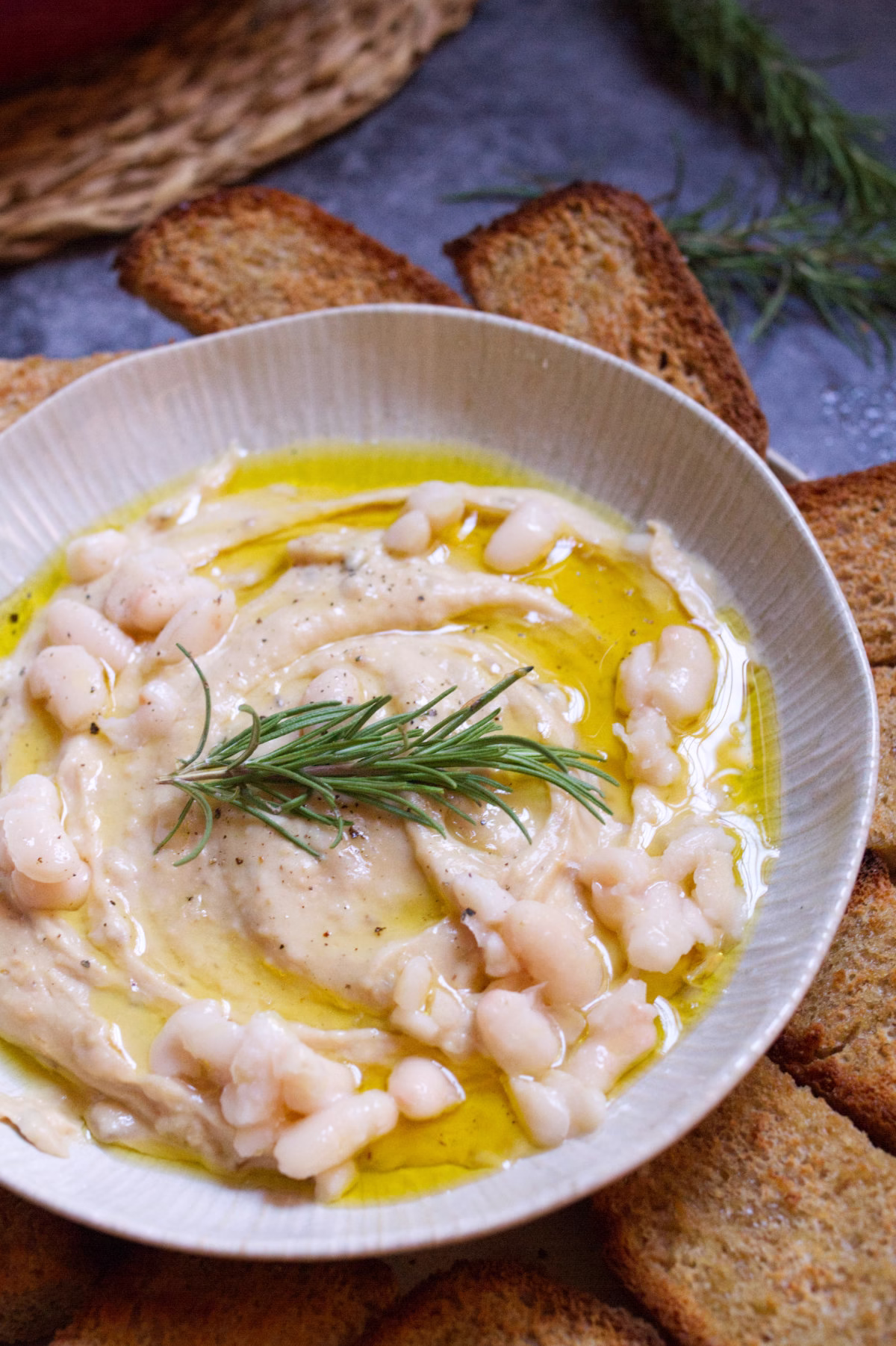 A small bowl of white bean dip with caramelized onions