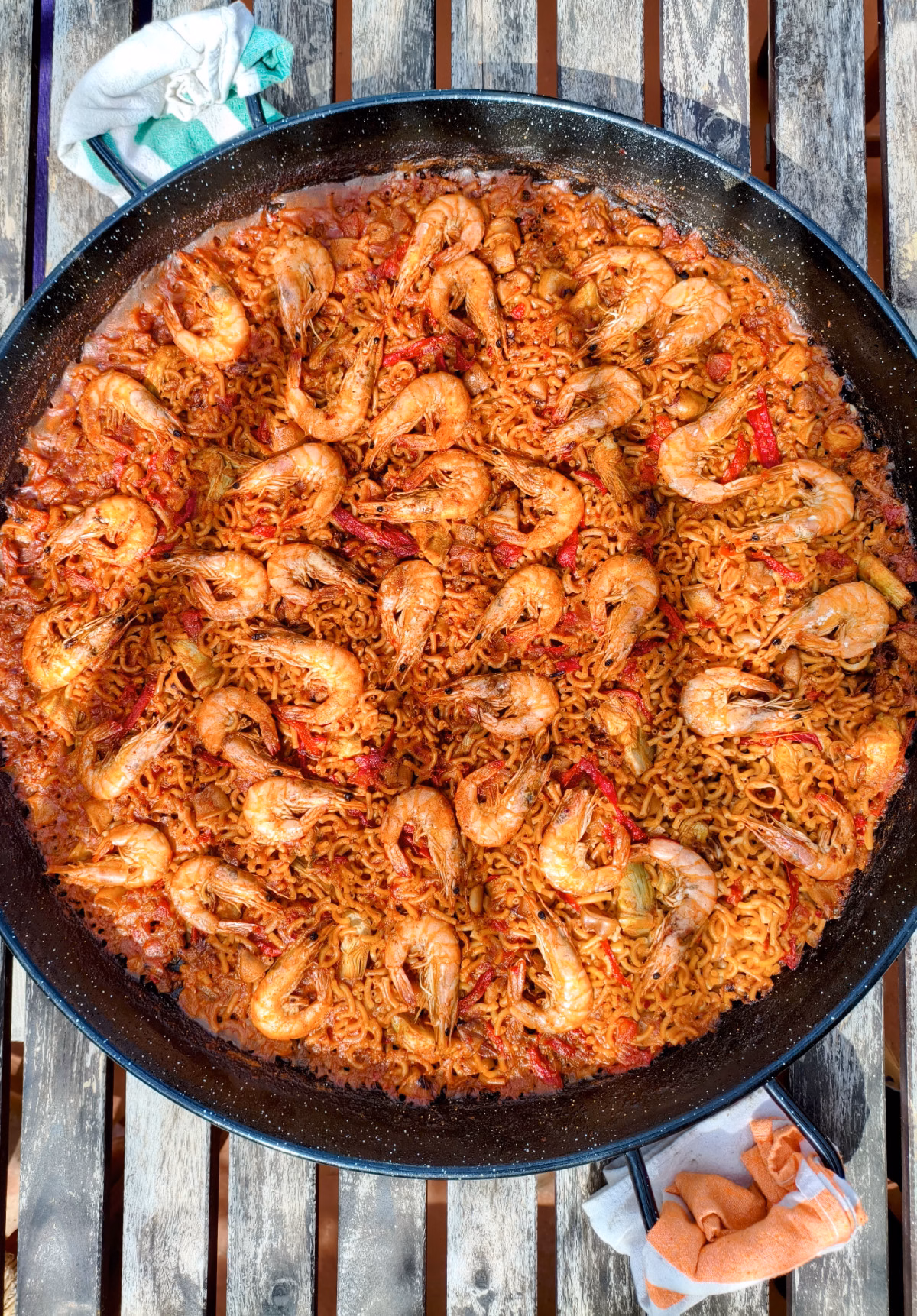 A large pan of seafood fideua topped with prawns