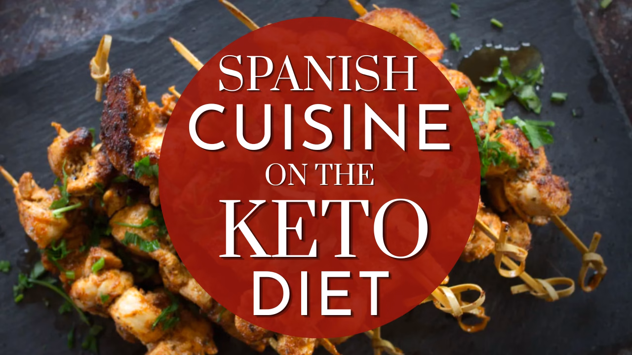 Chicken skewers on a slate plate with text over it: Spanish cuisine on the keto diet.