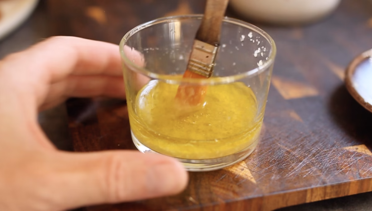 Whisking the dressing to emulsify the olive oil