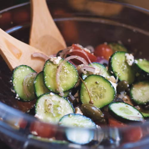 A Mediterranean cucumber salad in a large bowl being served