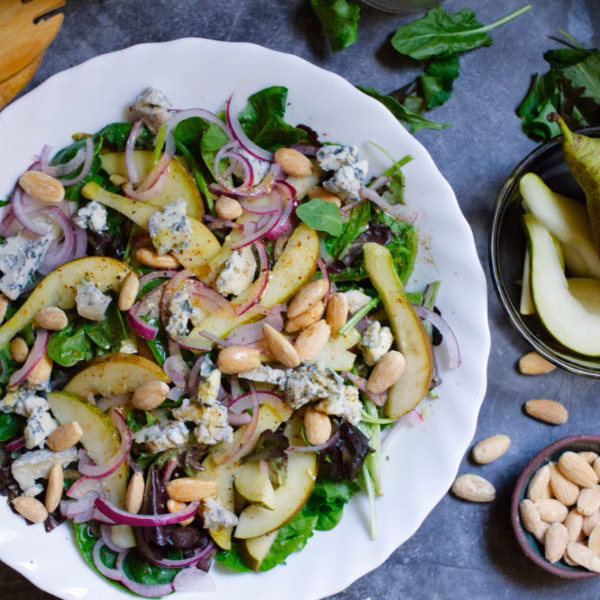 Pear and Blue Cheese Salad besides a bowl of almonds and pears