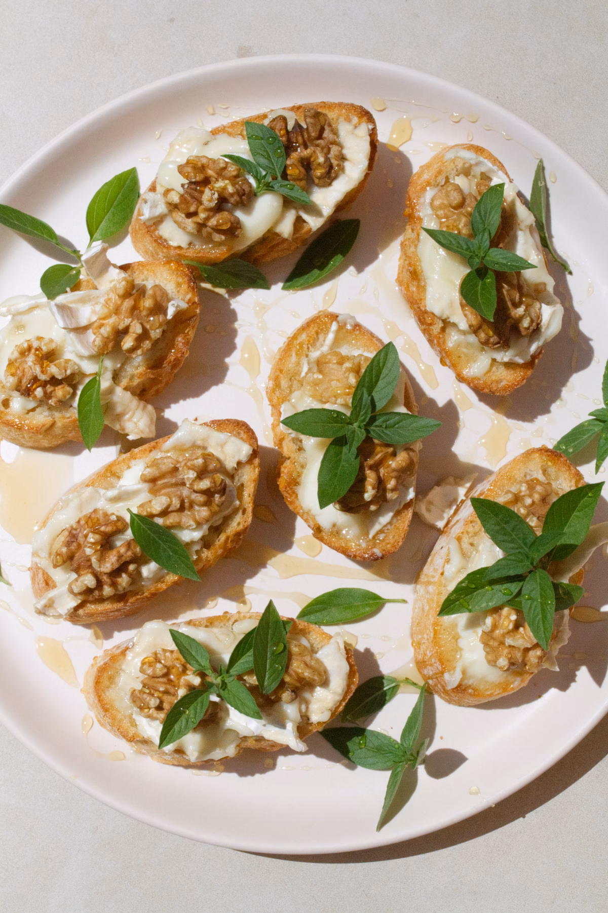 A platter of Goat cheese pintxos with walnuts and drizzled with honey