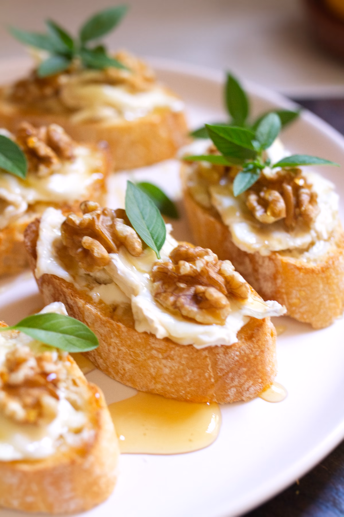 A platter of Goat cheese pintxos with walnuts and drizzled with honey